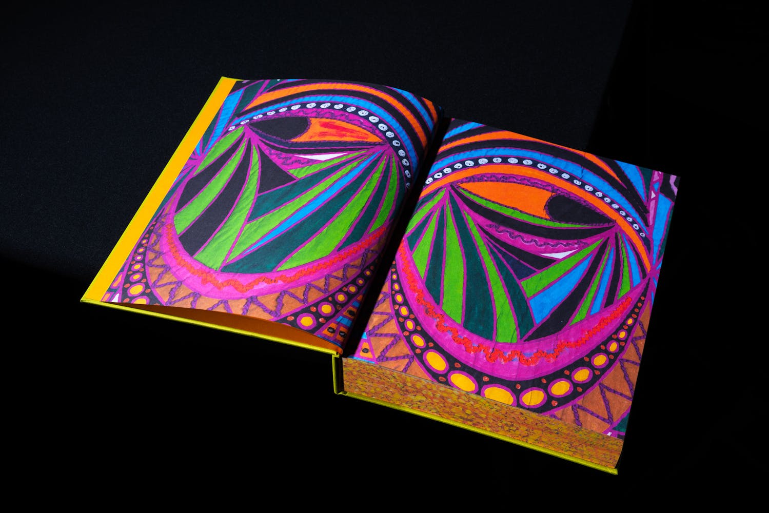 Spread of a book with colorful paintings.