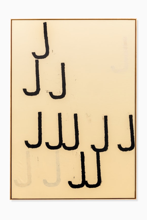A series of the letter J are painted in black on an unbleached canvas.