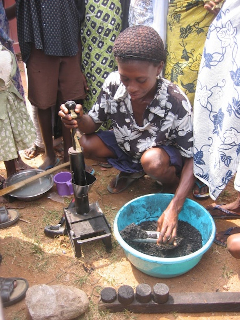 Making the high-density briquettes using a press, Jukwa market, Ghana, 2005