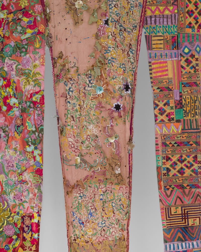 Close up image of an artwork made from a mixture of colorful fabircs and sewing techniques.