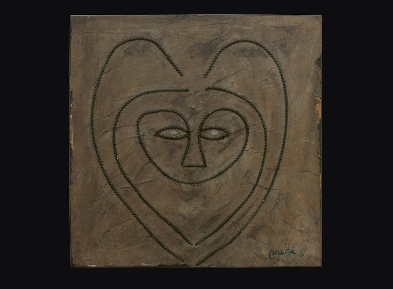 Painting of a face in a heart shape.