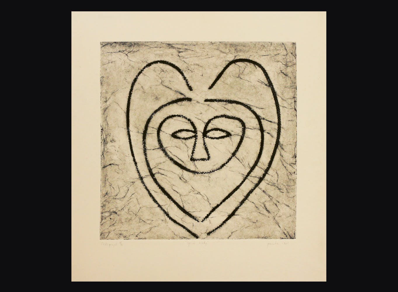 Print of a face in a heart shape.