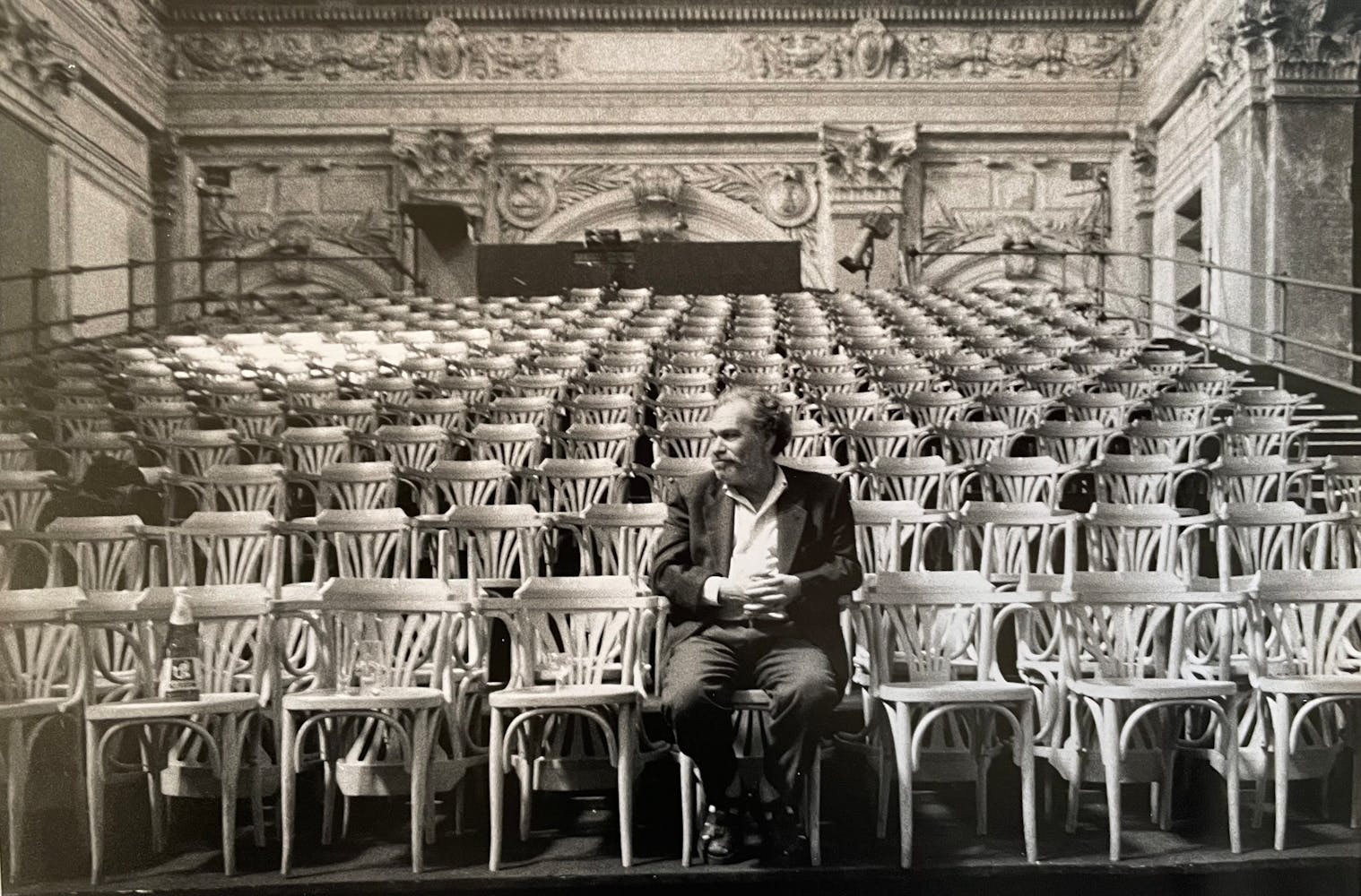 A man sits alone in a theater.