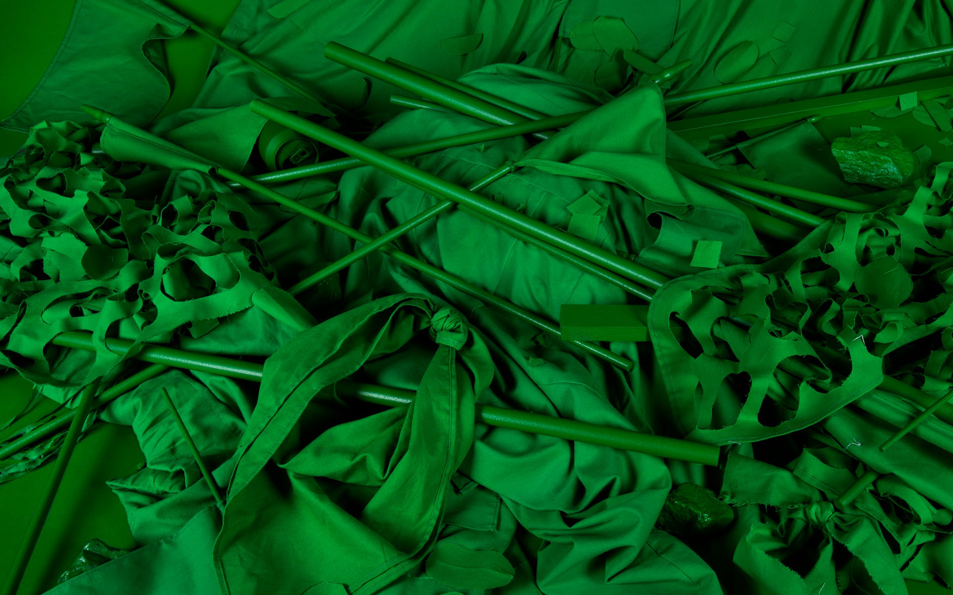 Image of all green fabrics and poles