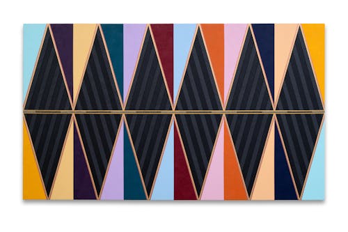 A large multicolored geometric abstract painting in black as well as shades of purple, yellow, blue, and, gold
