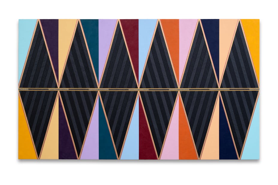 A large multicolored geometric abstract painting in black as well as shades of purple, yellow, blue, and, gold