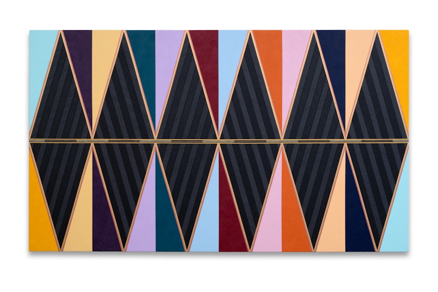 A large multicolored geometric abstract painting in black as well as shades of purple, yellow, blue, and, gold
