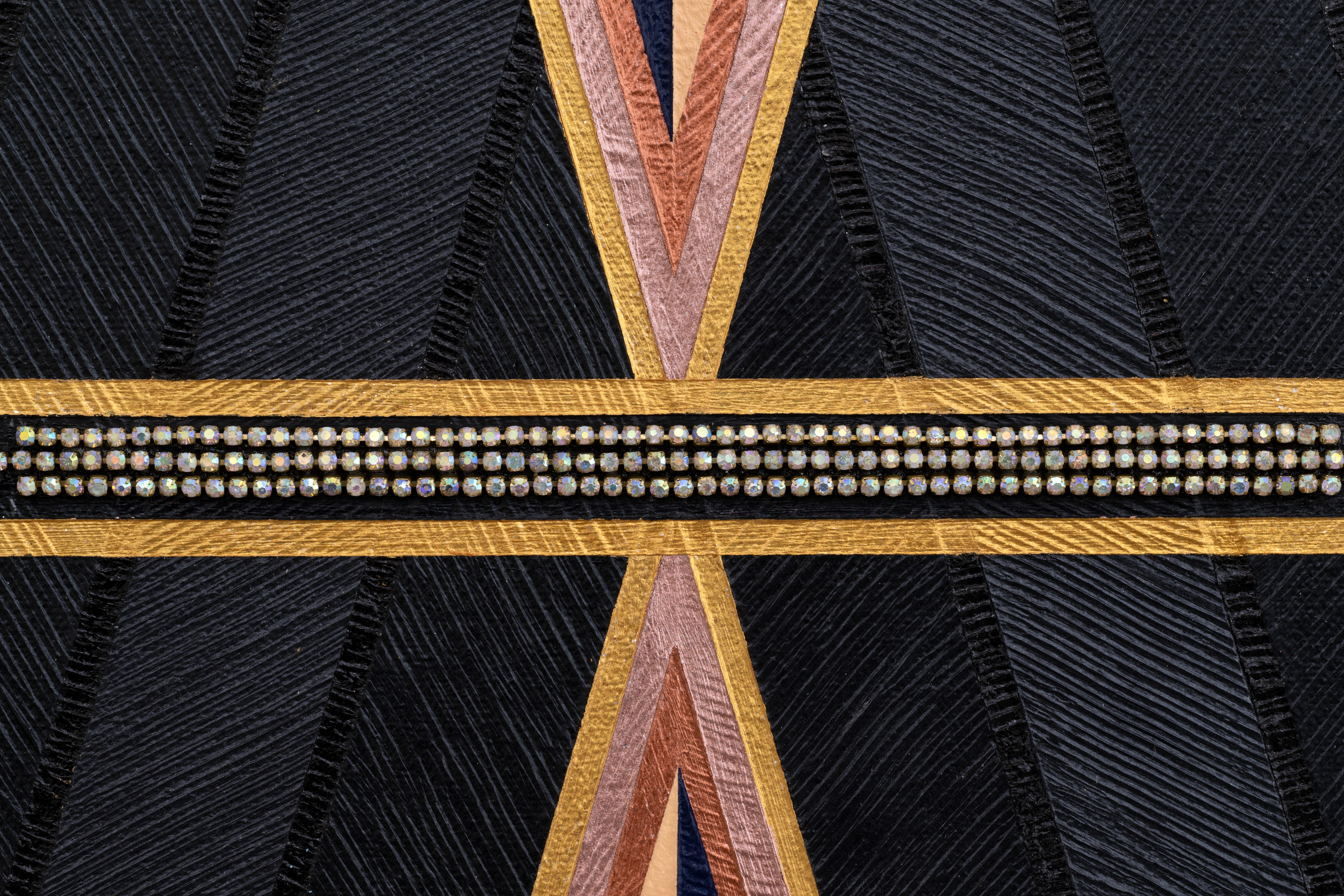 close up of a geometric painting with a chevron pattern of triangles with tips touching at the center vertical axis, three lines of rhinestones run across the horizontal axis.