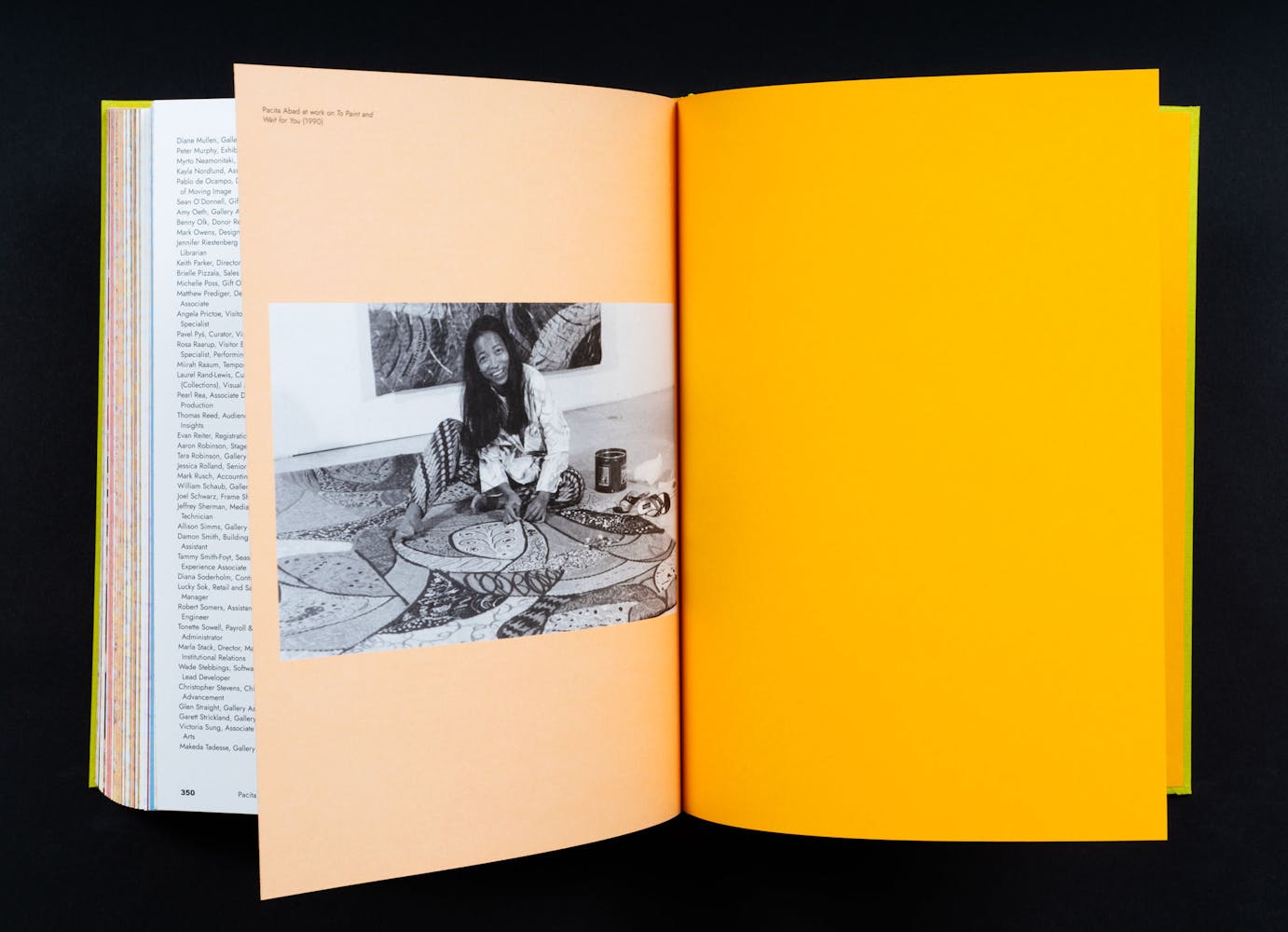 Spread of a book with an image of a woman smiling at the viewer while working on an artwork.