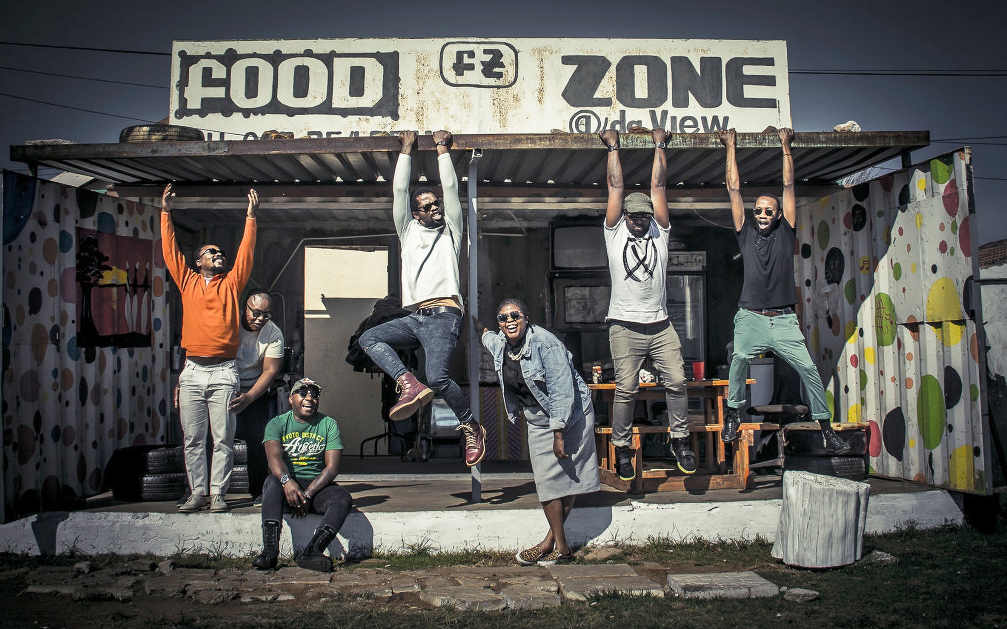 BCUC posing under a sign that says food zone.