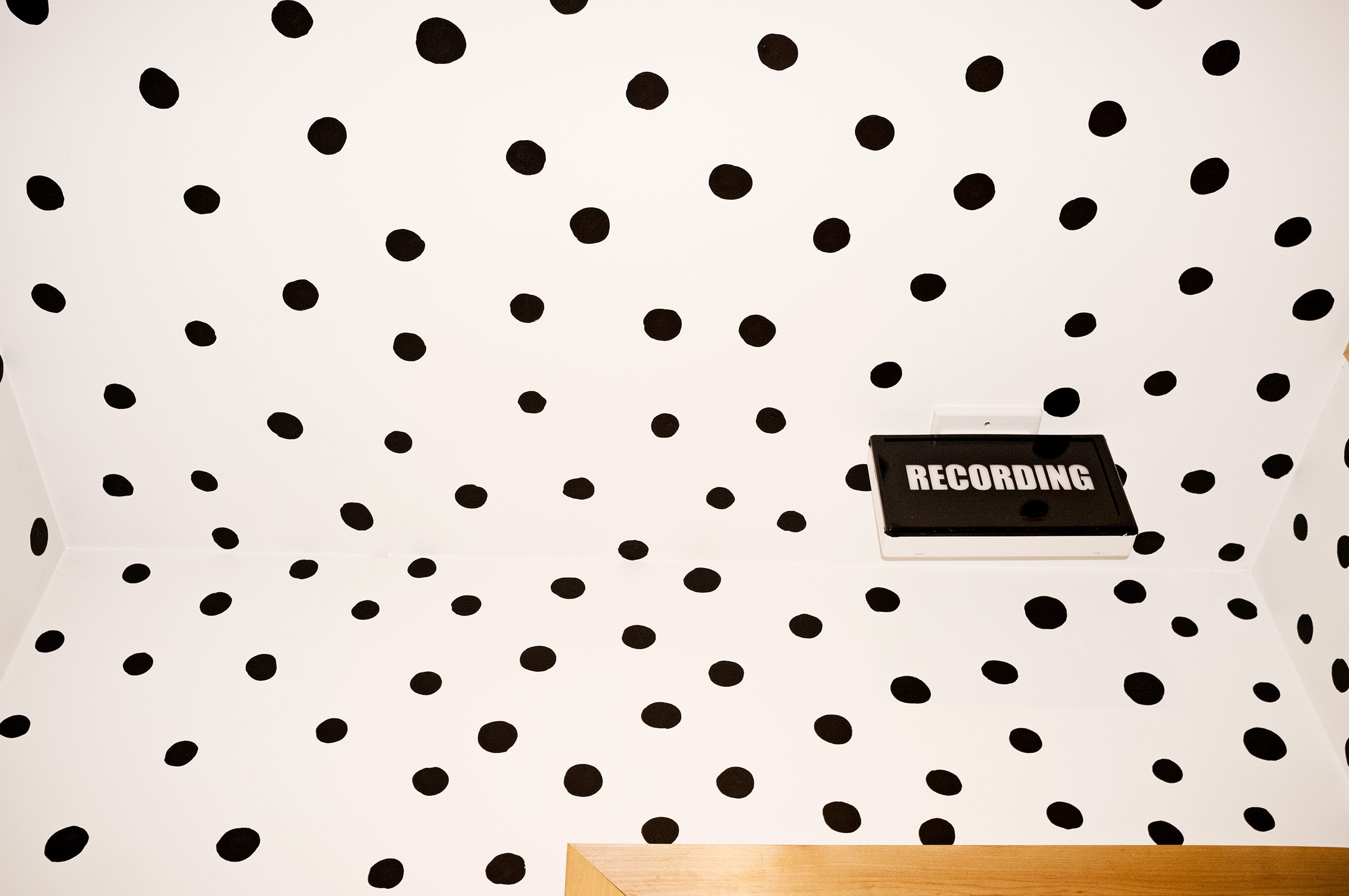 dotted pattern room with recording sign