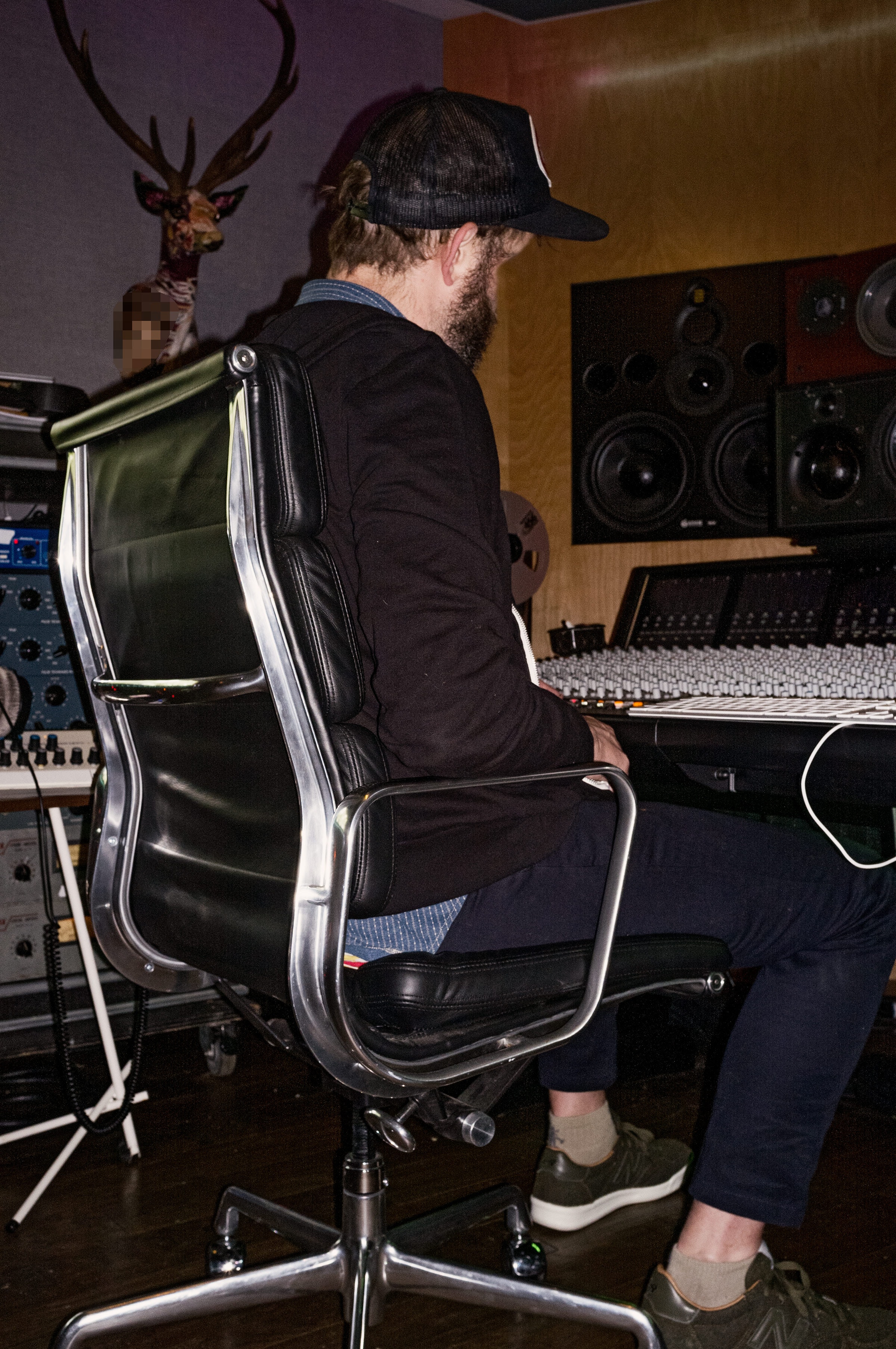 view of man sitting at piano from behind