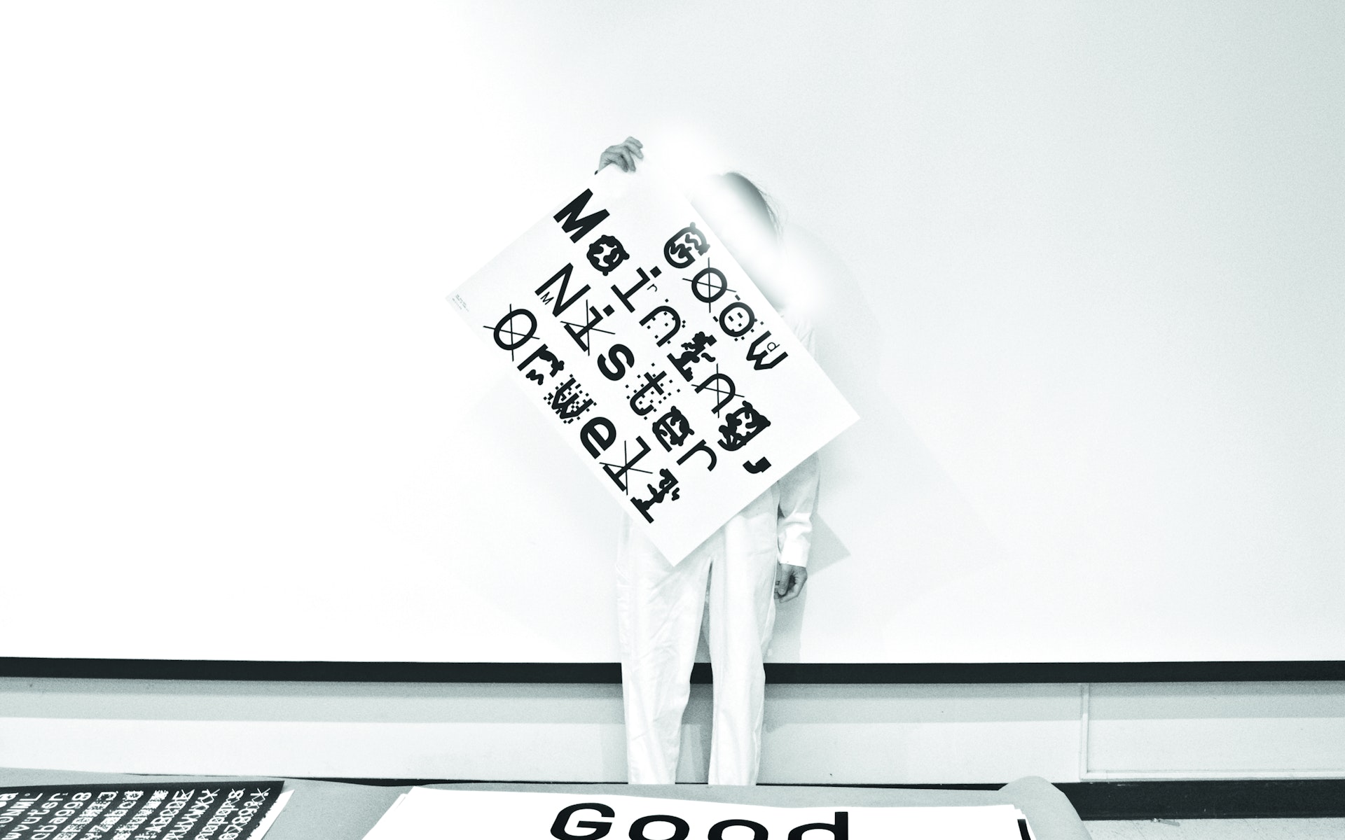 Designer Sang Mun holding a poster displaying his typeface ZXX.