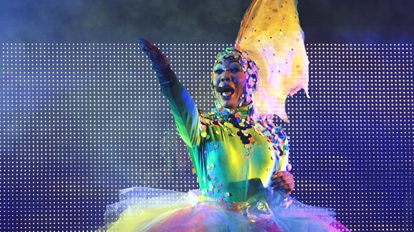 BeBe Zahara Benet performing in colorful dress and headdress.