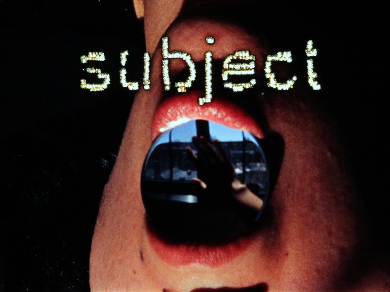 Close up of a mouth, upside down, with an image of a hand in front of a window inside of it, and the word “subject” overlaid.