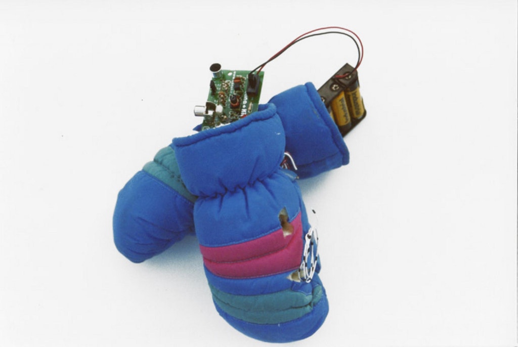 Winter mittens with a battery pack and a mother board inside, attachted with wires.