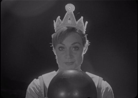 Woman wearing crown holds bowling ball