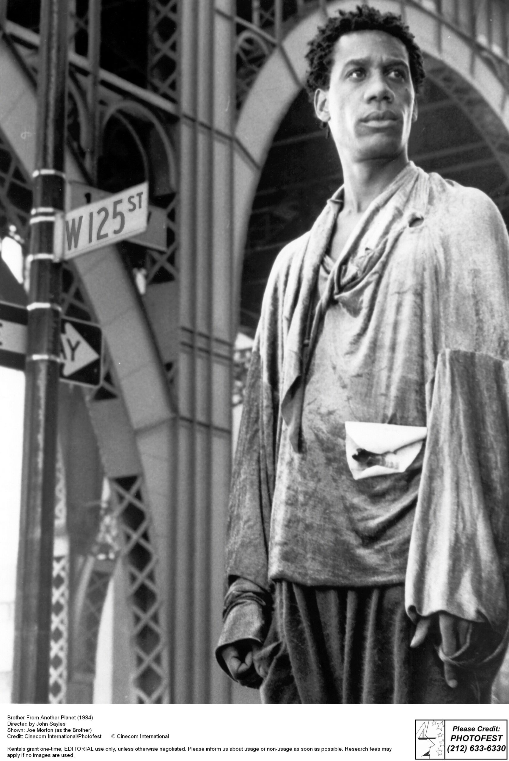 Man standing near elevated bridge