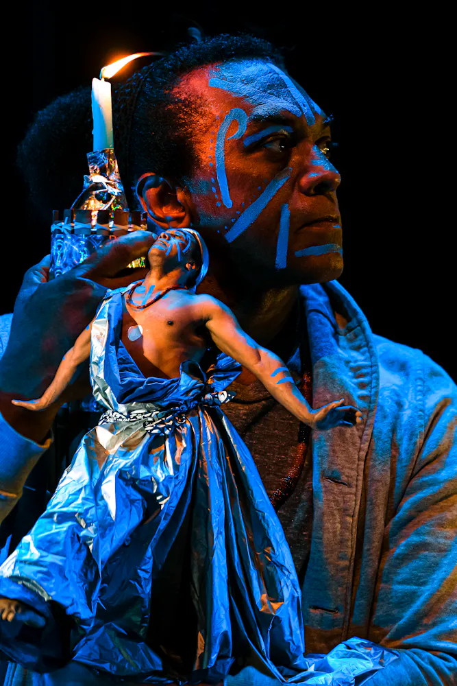 image of dancers superimposed on each other, bathed in colorful light with black background