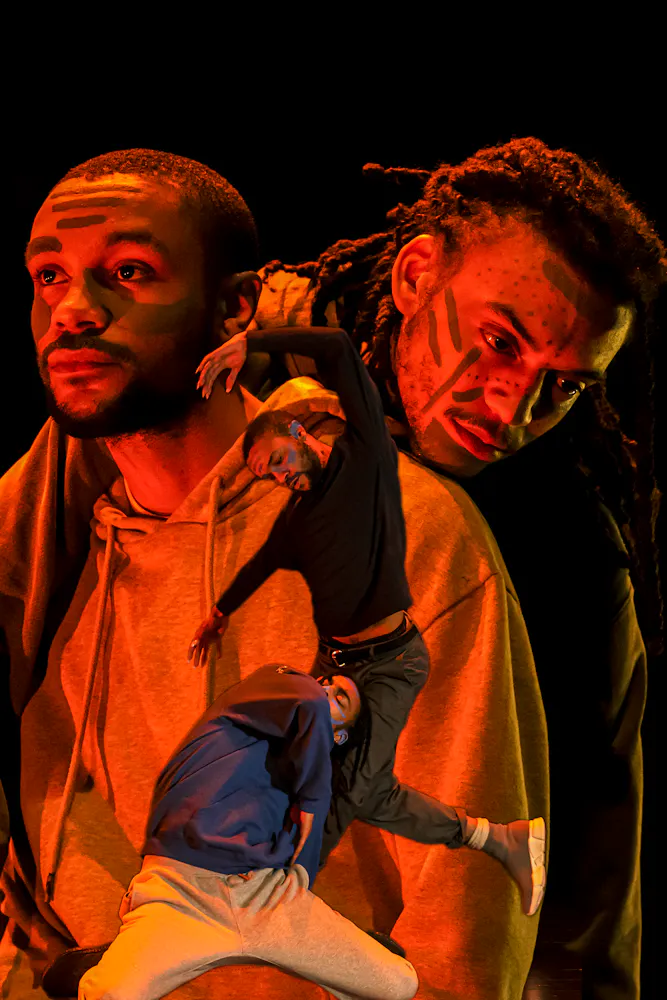 image of dancers superimposed on each other, bathed in colorful light with black background