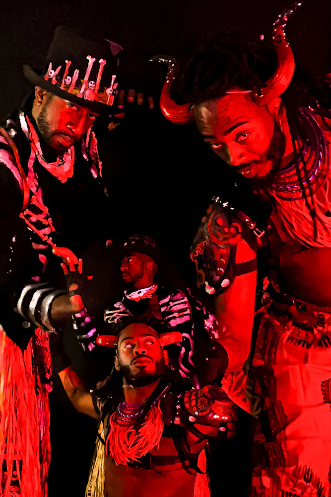 image of dancers superimposed on each other, bathed in colorful light with black background