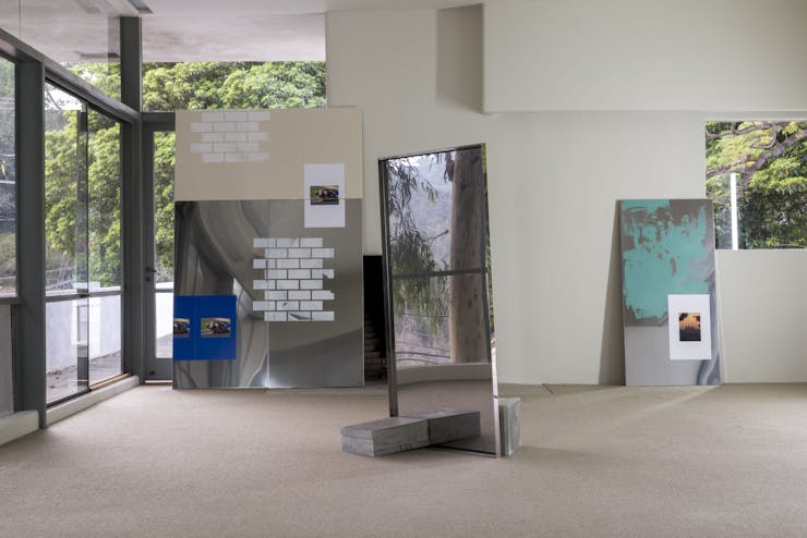 Image of lobby space with images and mirrors laying against walls