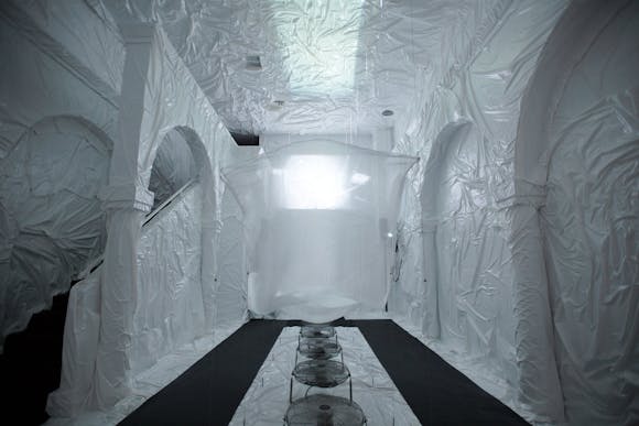 Image of gallery space with walls covered with white wrinkled practice