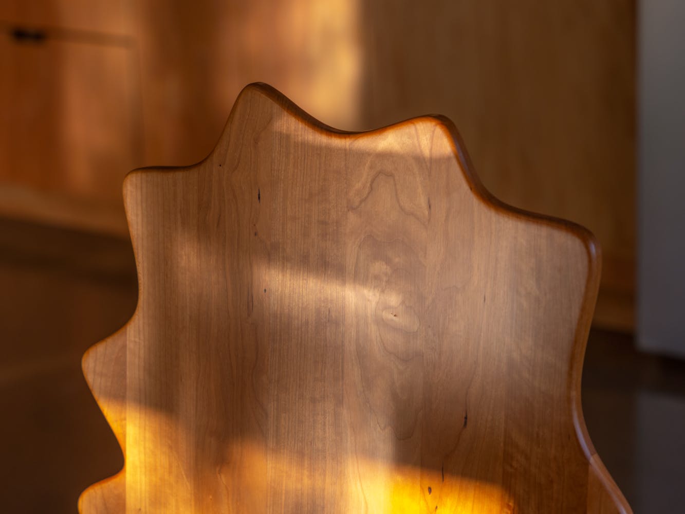 The top of a wavey wooden chair.