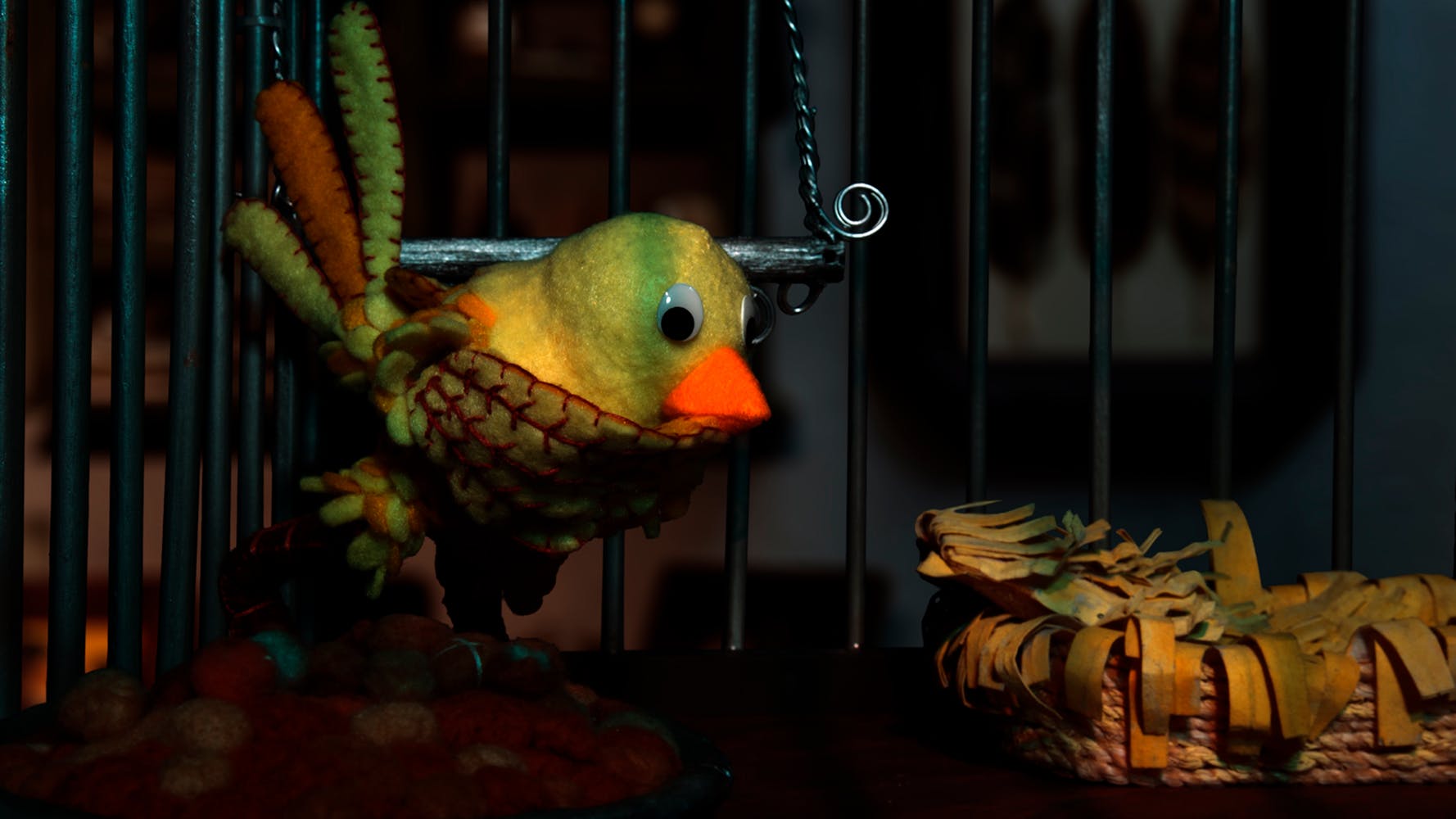 Yellow felt bird in a cage