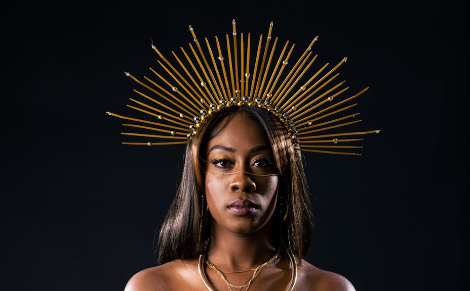 Image of woman wearing large golden head crown