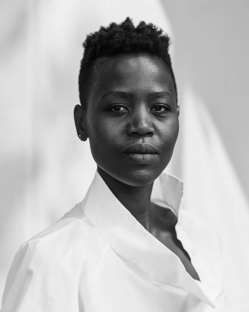 Grayscale portrait of woman in white shirt on white background