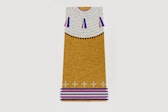 A tan piece of art with blue and purple stripes at the bottom and
