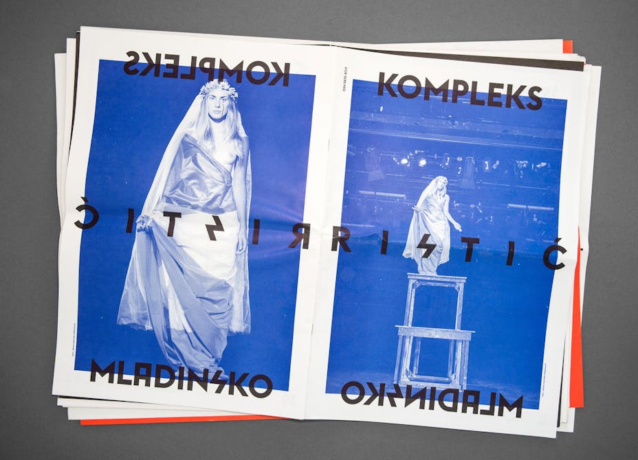 Theater programme is laid out on a table.