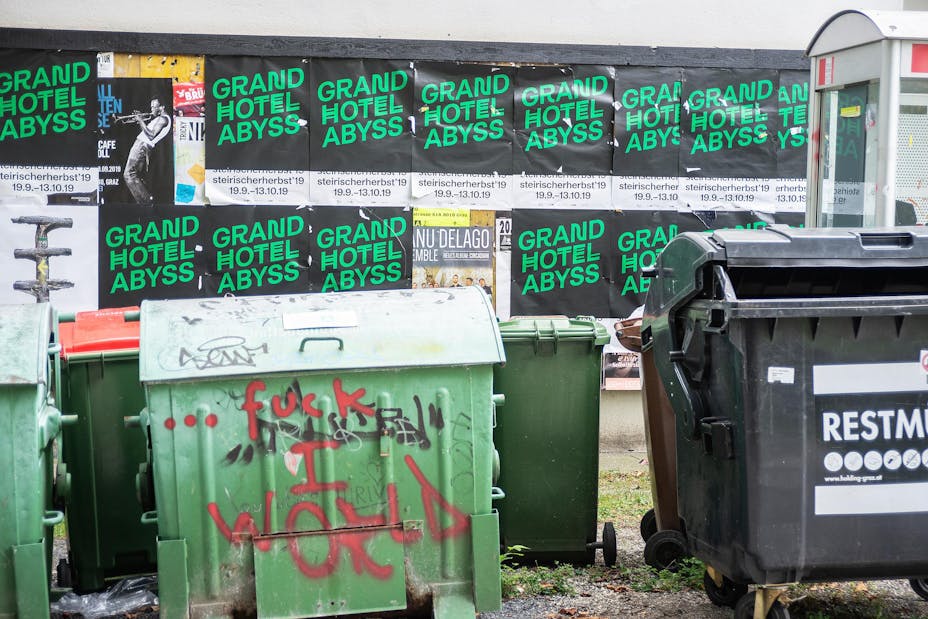 Posters line an alley.