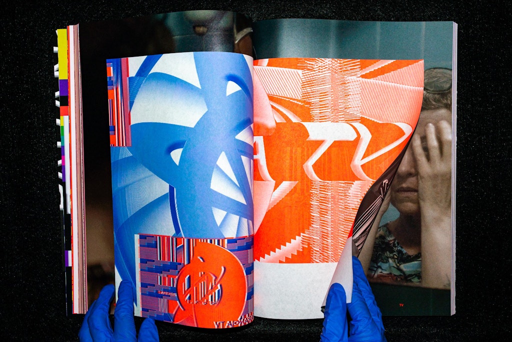 Hands wearing plastic gloves flip through a book.