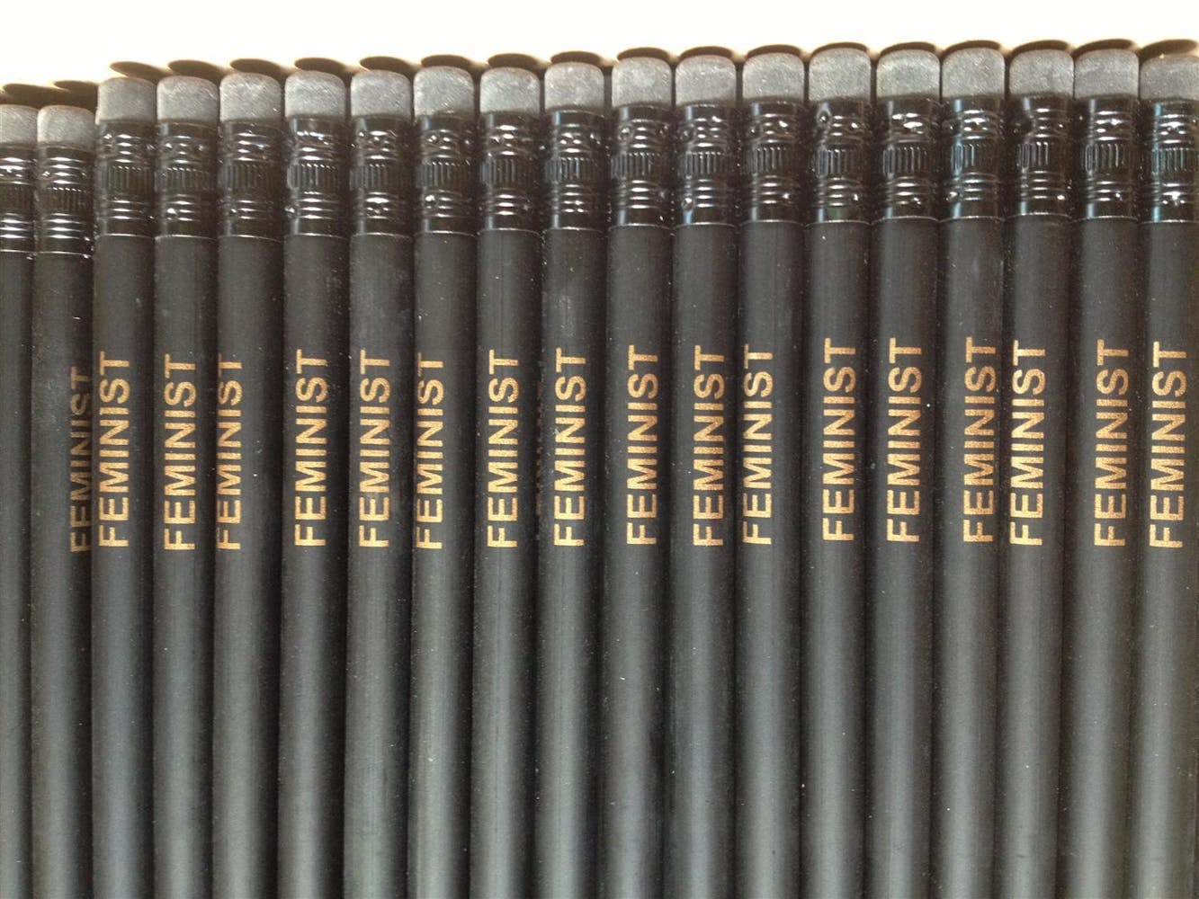 A series of black penicls with the word 