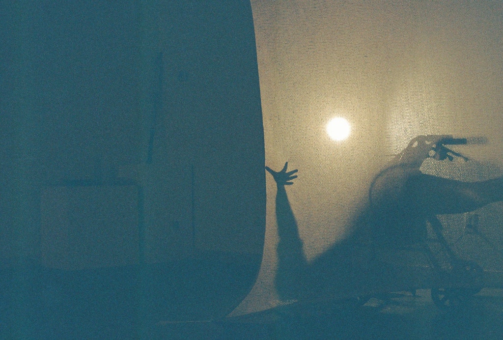 Grainy film photograph of D. Allen performing 