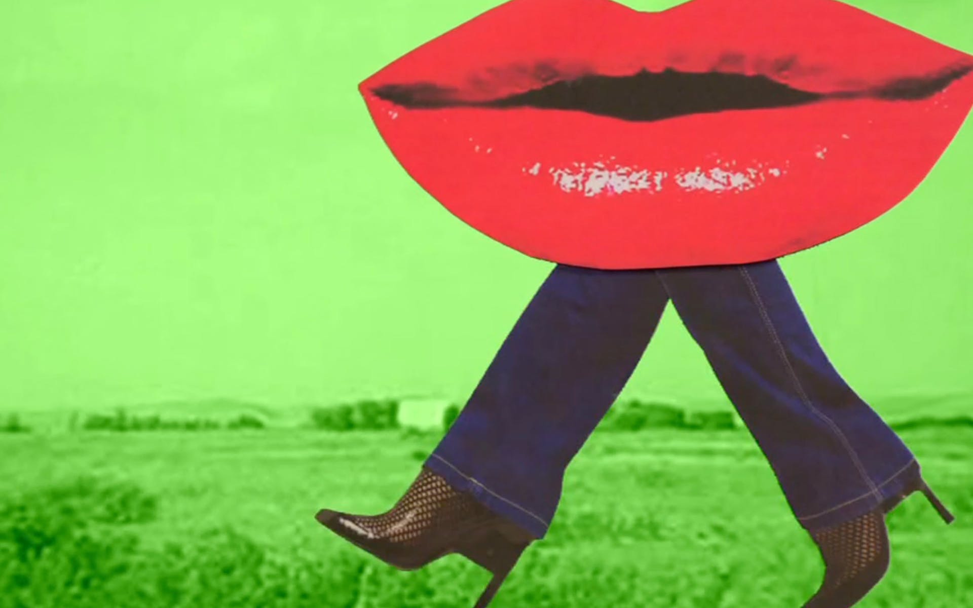 Film still featuring animation of giant red lips attached to legs on green background