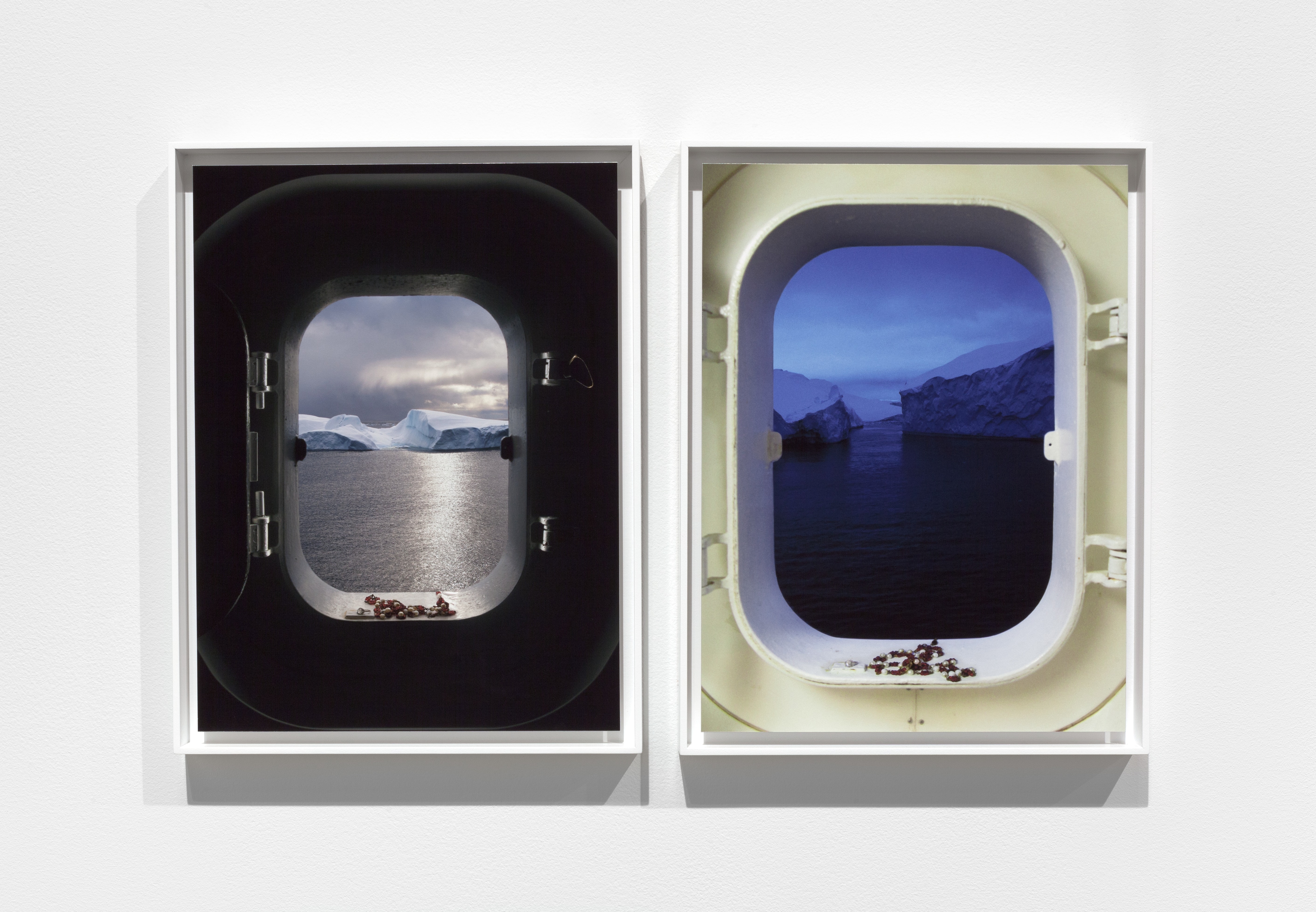 Two port windows side by side, one at daylight and one dusk.