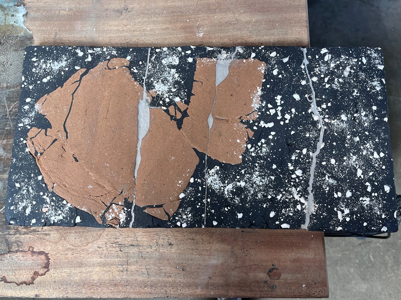 A ceramic artwork lays on a table.