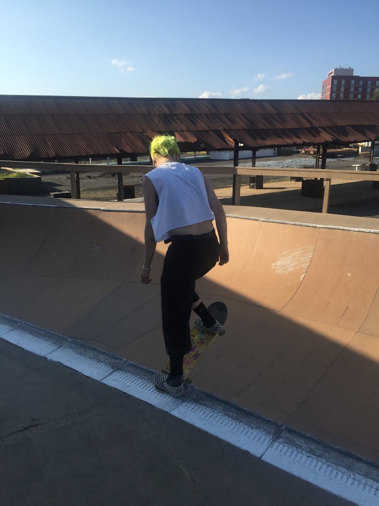 An adult skateboards outside.