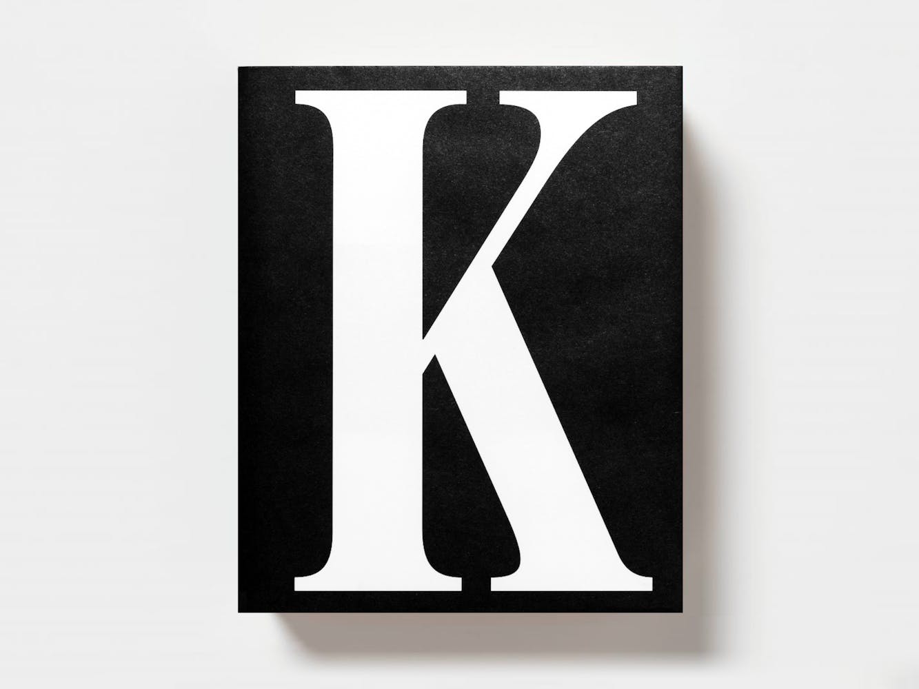 Cover of a book with a large white letter K on black background.