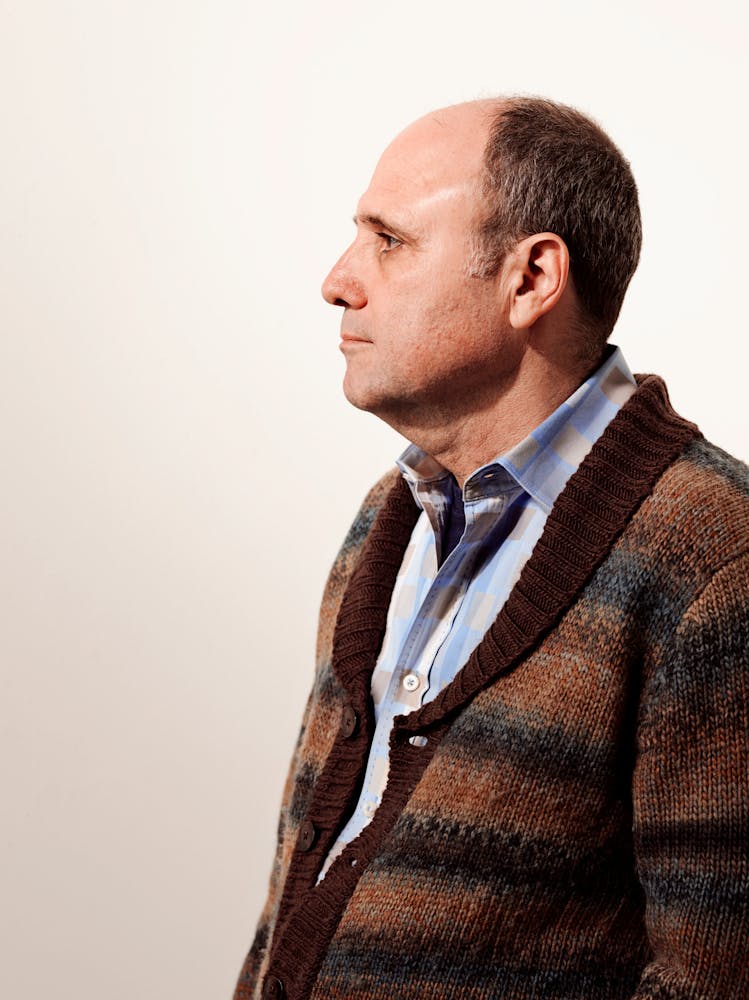 A man sits in profile.