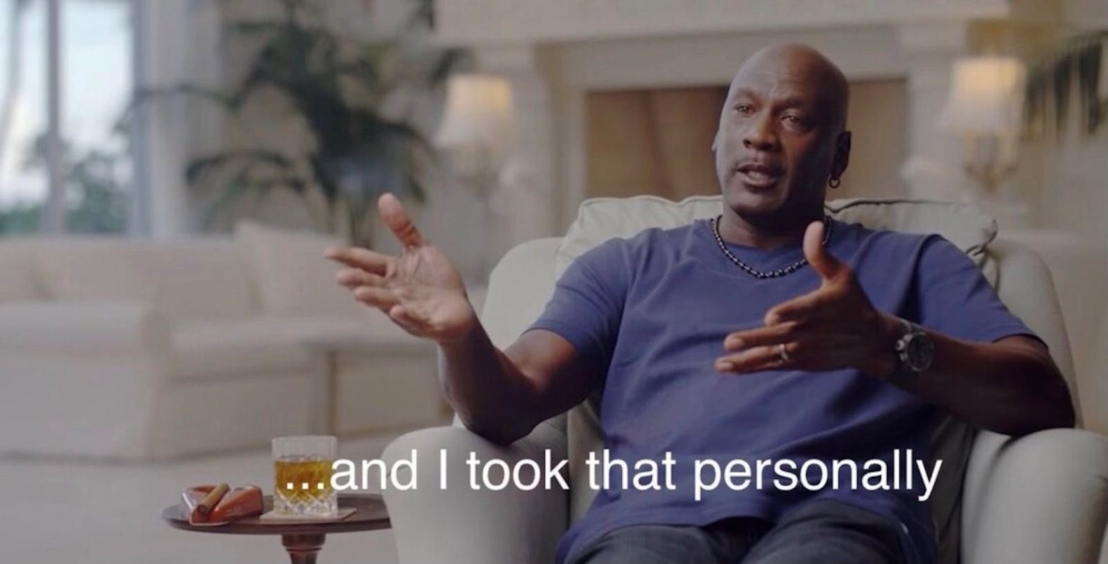 Still of Micheal Jordan sitting on a chair talking to a viewer offscreen. Text at bottom says 