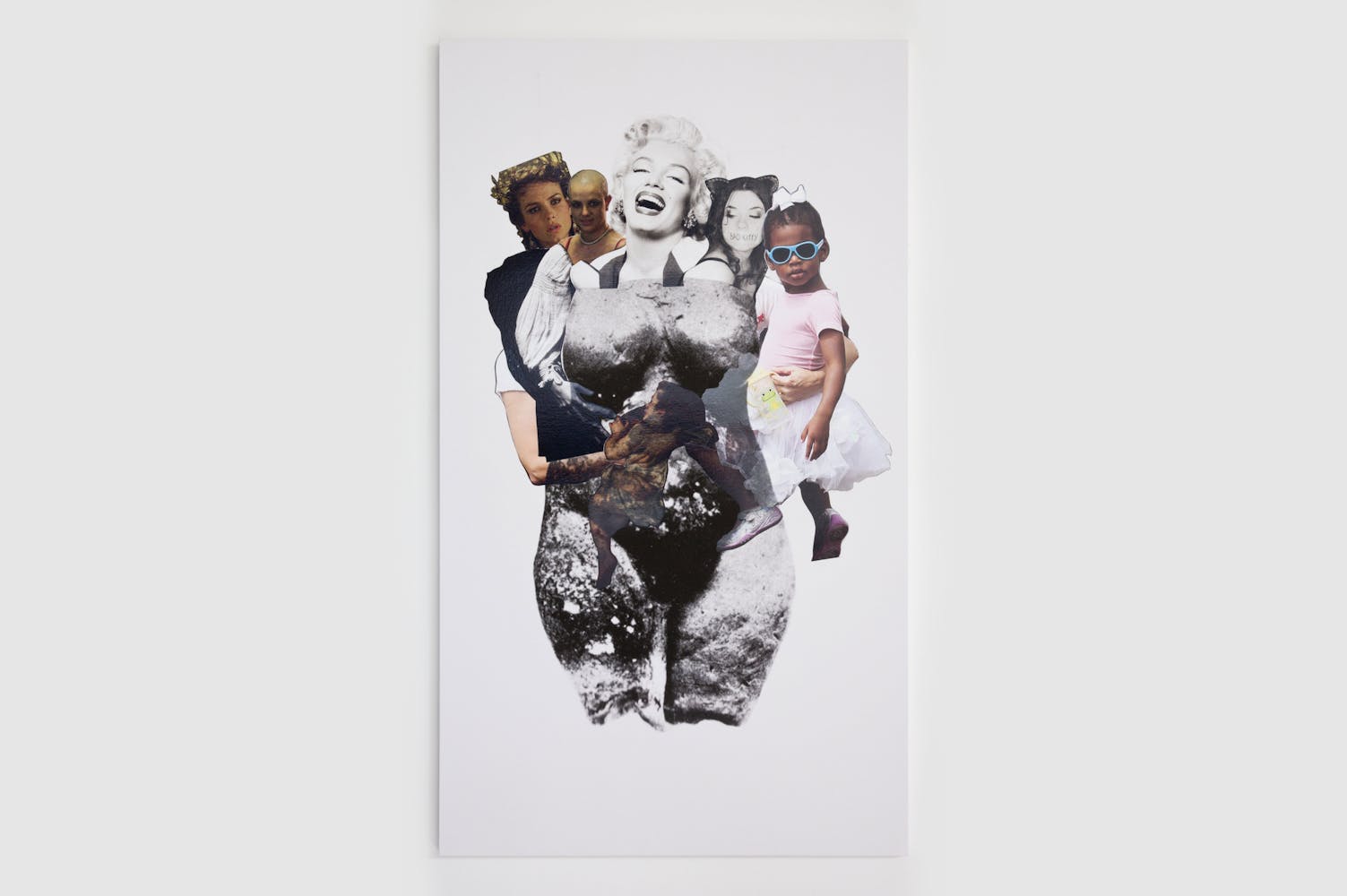 A collage of female heads including Marilyn Monroe and Britney Spears atop the body of a feminine statue, cradling the bodies of two children.