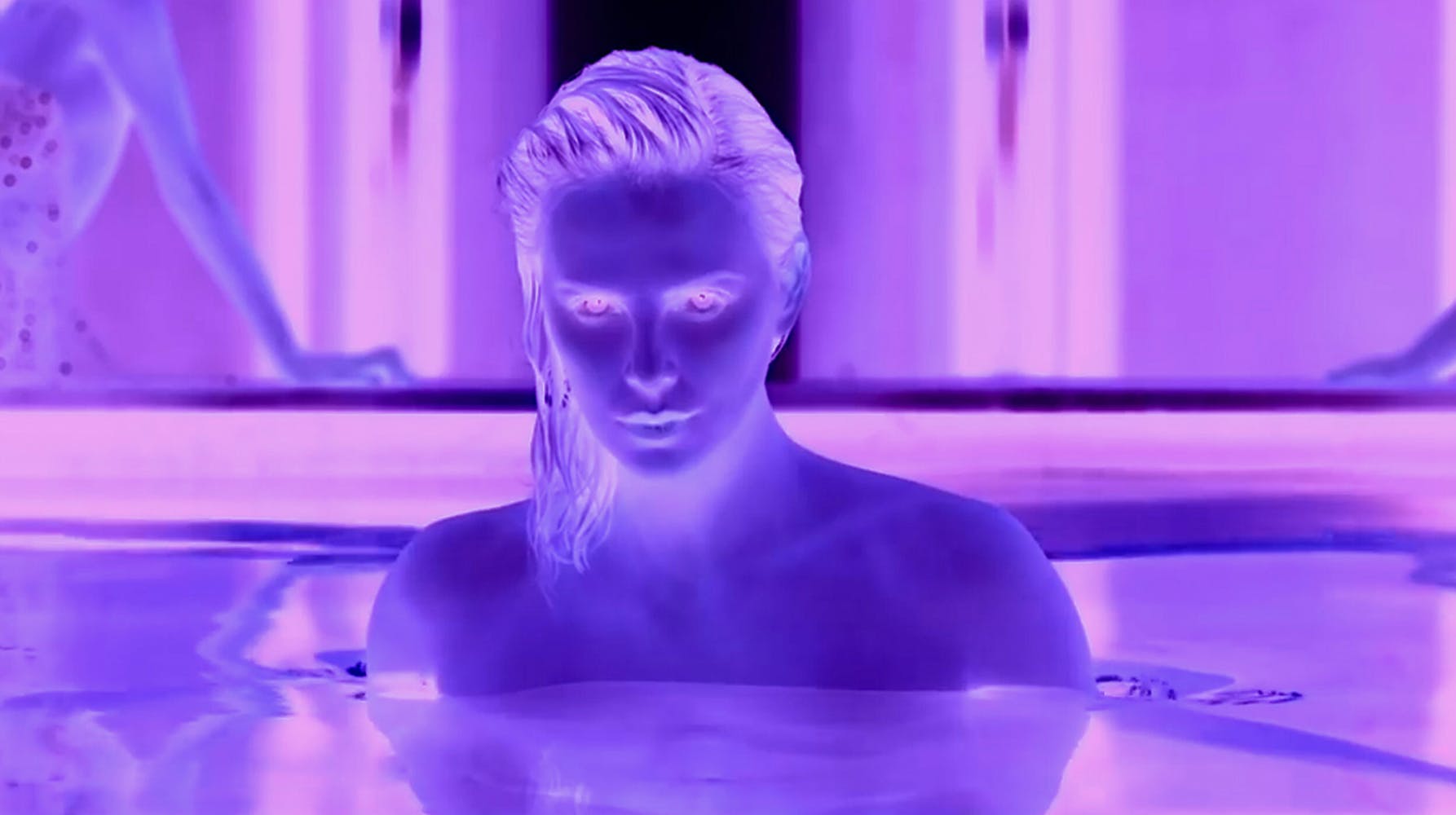 Inverted purple image of woman in water