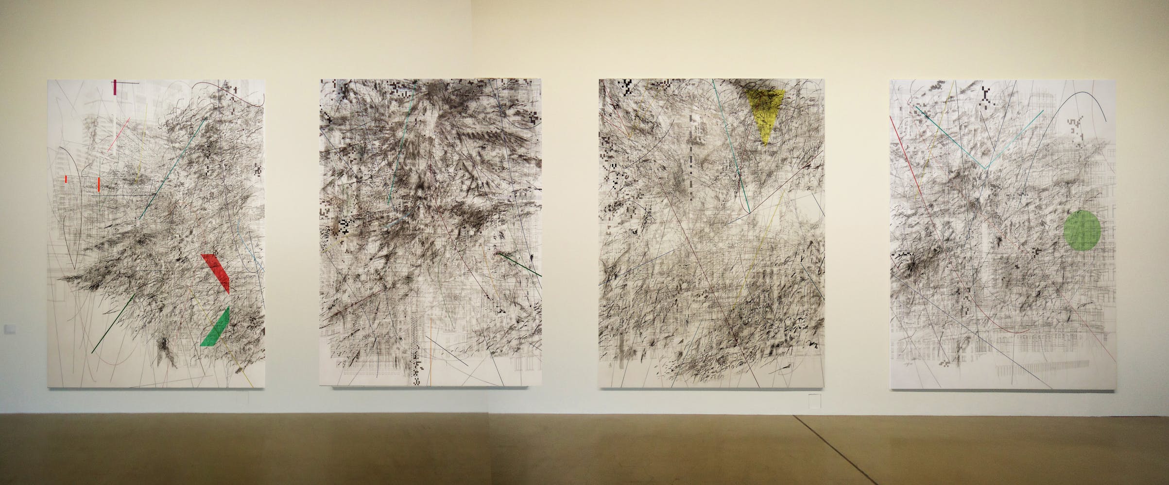 Four large abstract paintings with detailed line work hanging on a gallery wall