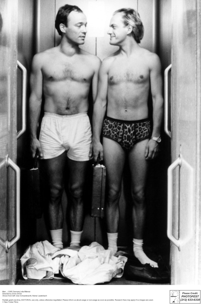 Black and white photo of two men in their underwear.