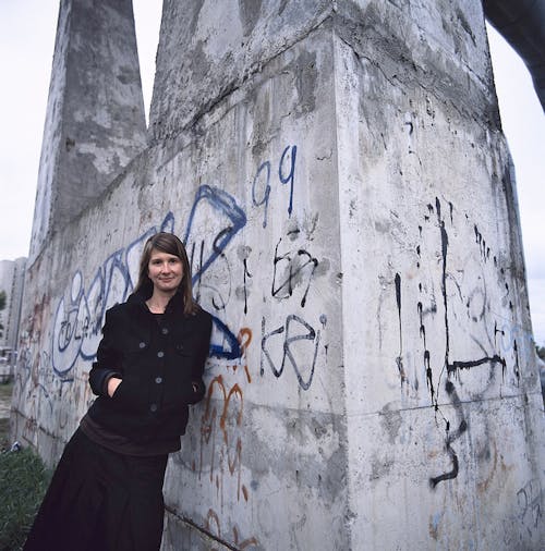 Monika-Sosnowska standing in front of a rock.