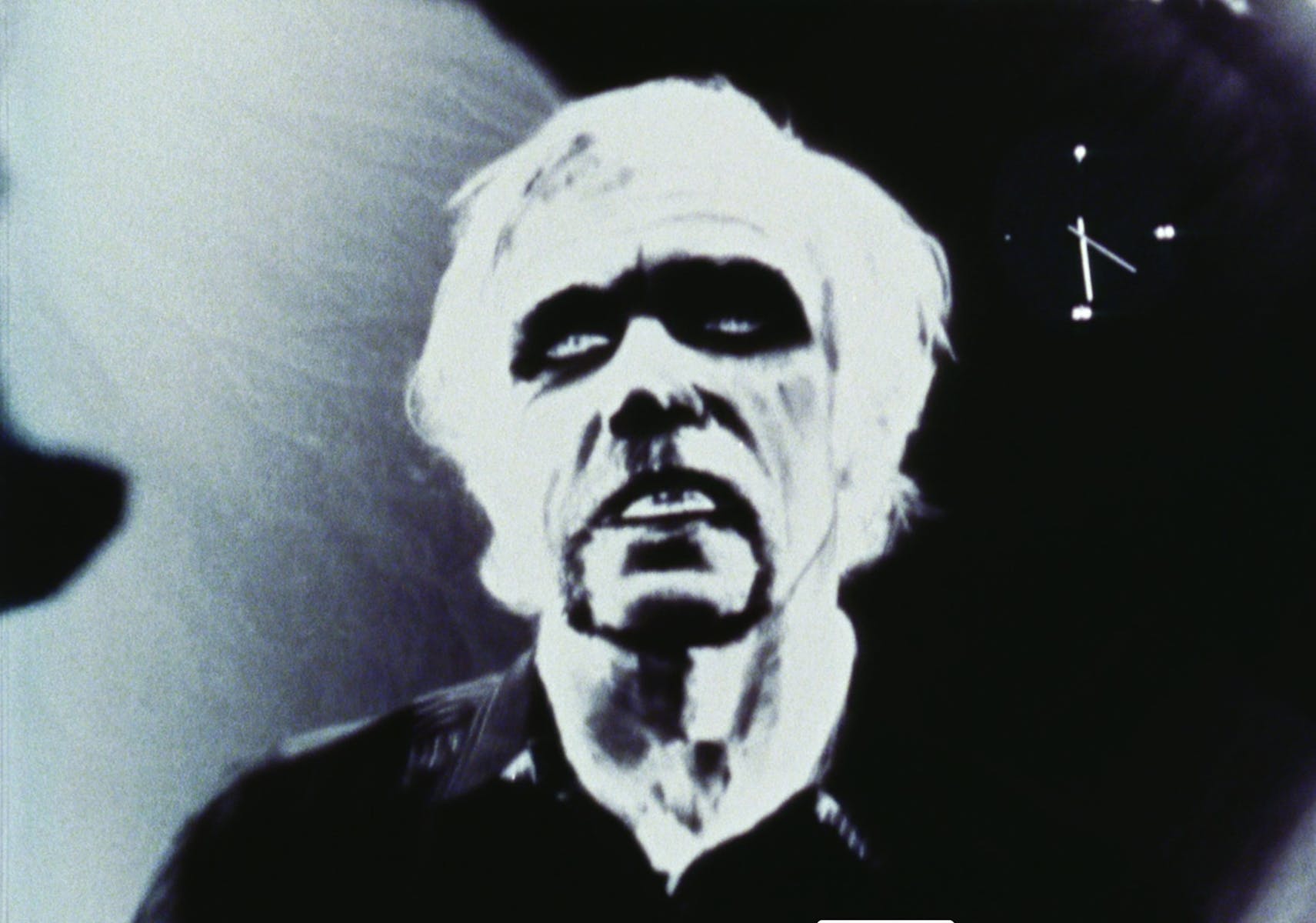 Black and white film still of high contrast man's face